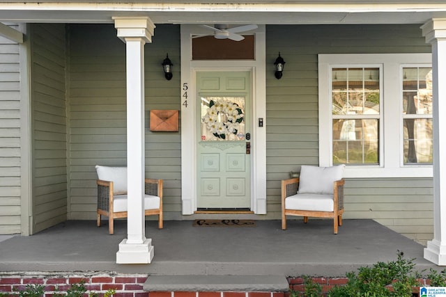 entrance to property featuring covered porch and ceiling fan