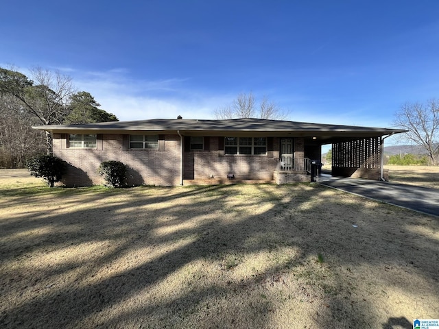 ranch-style home featuring a carport and a front yard