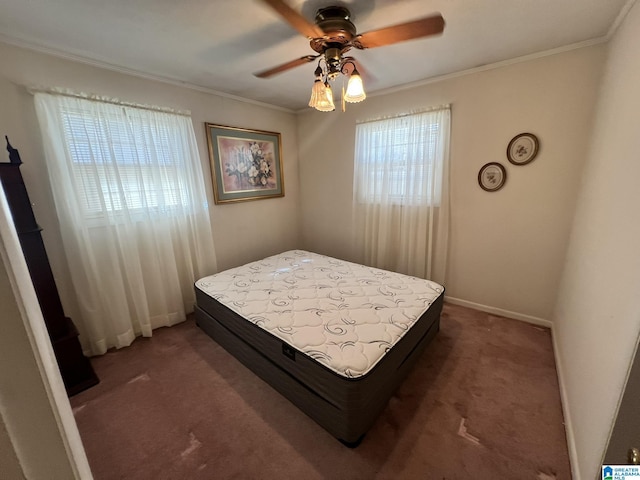 carpeted bedroom with ceiling fan and ornamental molding