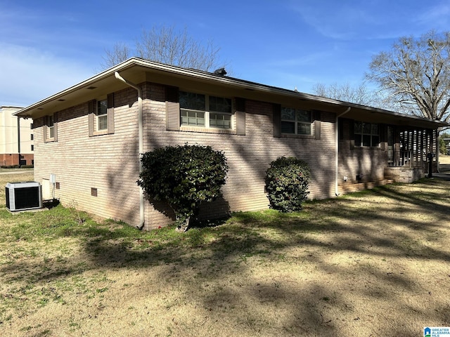 view of home's exterior featuring a yard and central AC unit