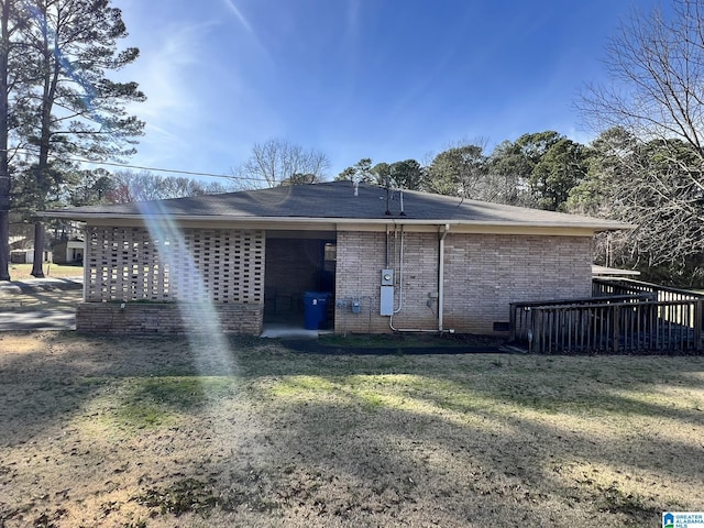 back of house with a lawn