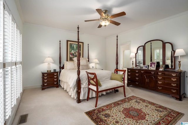 bedroom featuring light carpet, baseboards, visible vents, a ceiling fan, and crown molding