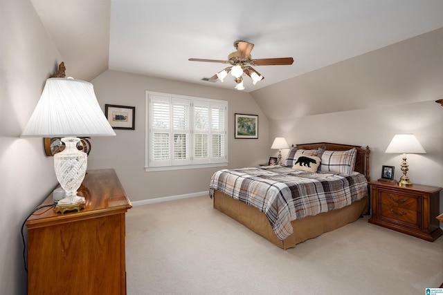 bedroom with light carpet, vaulted ceiling, a ceiling fan, and baseboards