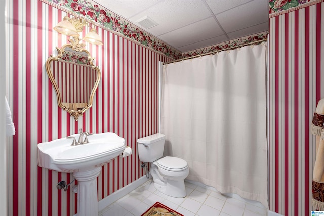 full bathroom with a paneled ceiling, tile patterned flooring, visible vents, and wallpapered walls