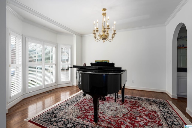 sitting room featuring dark wood-style floors, arched walkways, crown molding, and baseboards