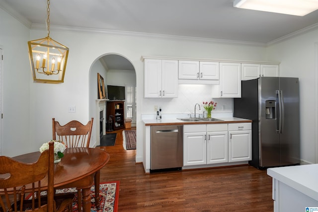 kitchen with stainless steel appliances, light countertops, and white cabinetry