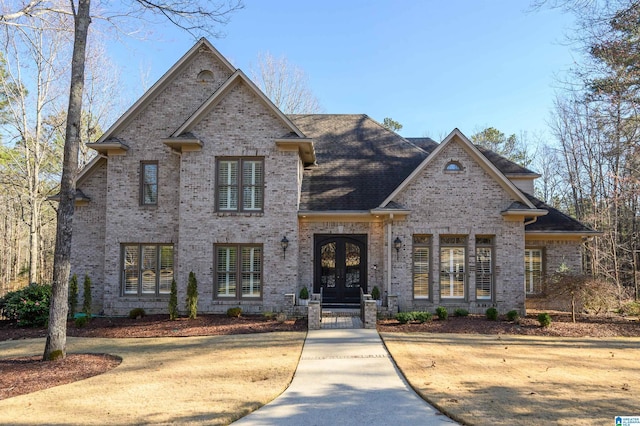 view of front of house with brick siding and french doors