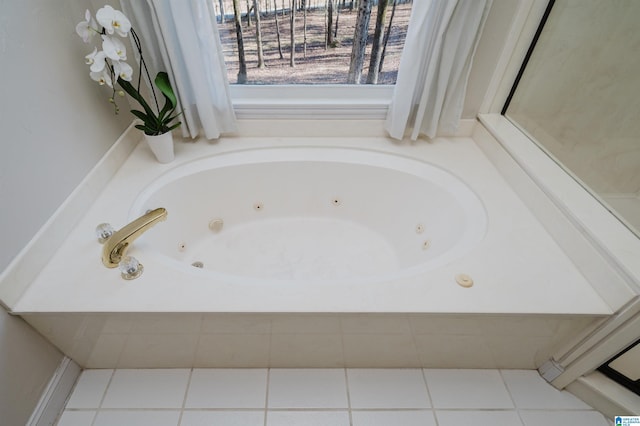 bathroom with a jetted tub and tile patterned flooring