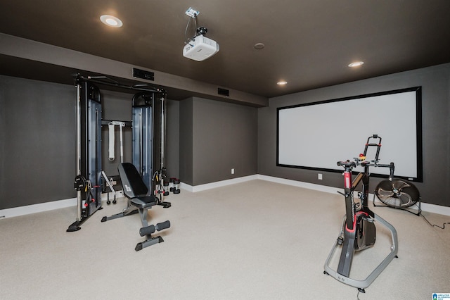 workout room with baseboards, light carpet, visible vents, and recessed lighting