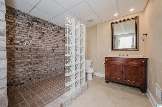 bathroom featuring a walk in shower, a drop ceiling, toilet, visible vents, and vanity