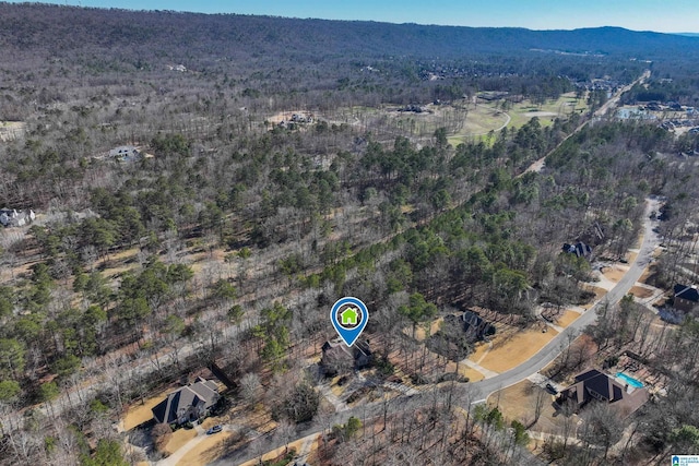 aerial view featuring a forest view and a mountain view