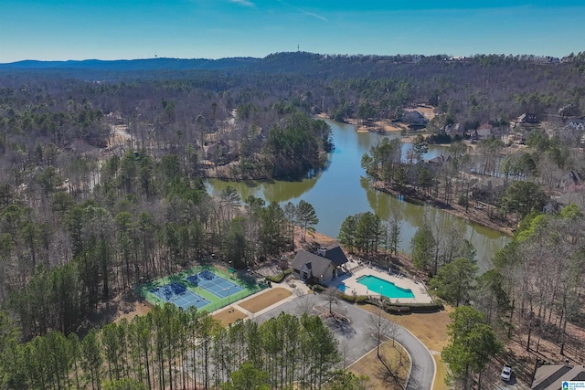 aerial view with a water view and a forest view