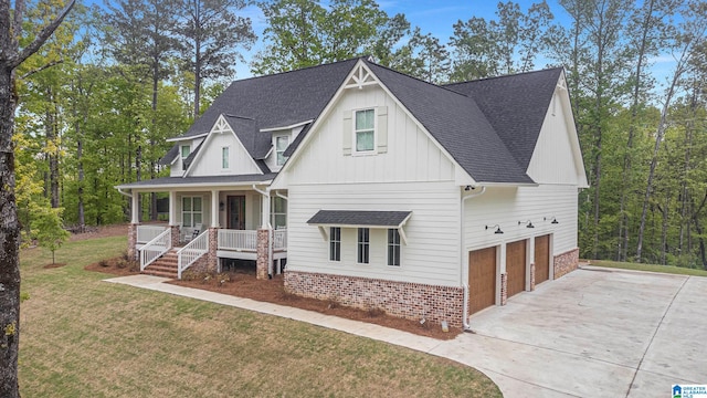 modern inspired farmhouse with a porch, a shingled roof, concrete driveway, a front yard, and a garage