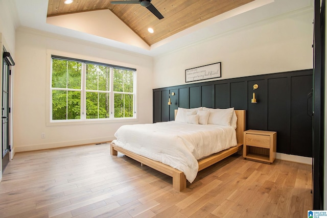 bedroom with lofted ceiling, wood ceiling, light wood-style floors, a decorative wall, and recessed lighting