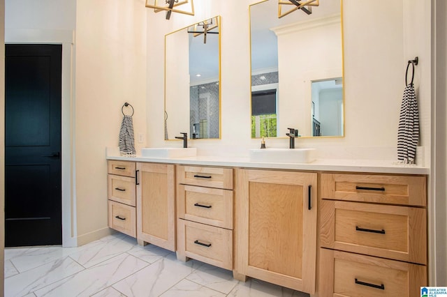 full bath featuring marble finish floor, a sink, baseboards, and double vanity