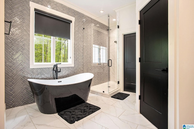 full bath featuring marble finish floor, tile walls, recessed lighting, a shower stall, and a freestanding tub