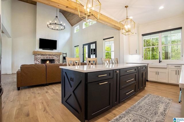 kitchen featuring light countertops, white cabinetry, and pendant lighting