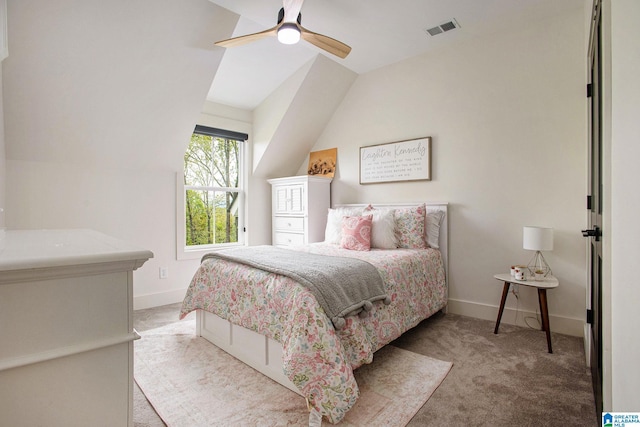 bedroom with ceiling fan, light carpet, visible vents, baseboards, and vaulted ceiling