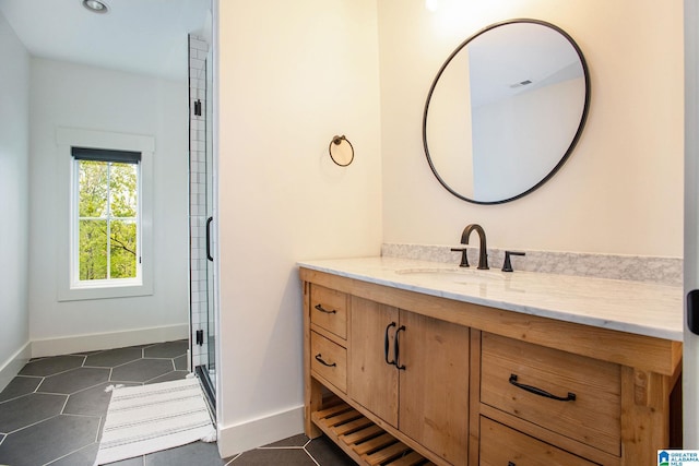 full bathroom featuring visible vents, vanity, baseboards, and tile patterned floors