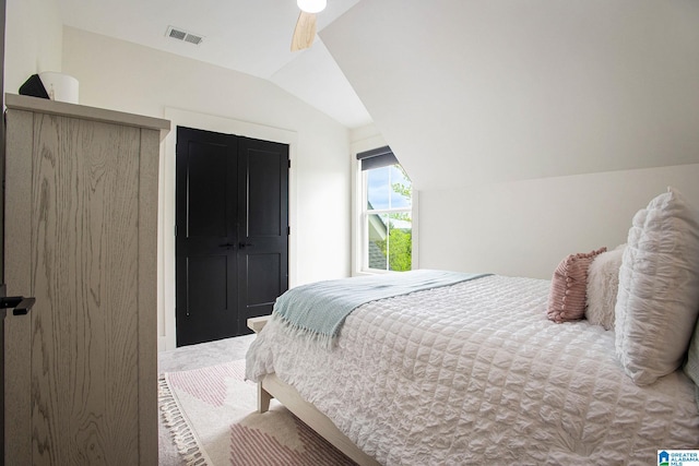 bedroom featuring a ceiling fan, carpet, visible vents, and vaulted ceiling