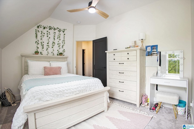 carpeted bedroom with vaulted ceiling and a ceiling fan