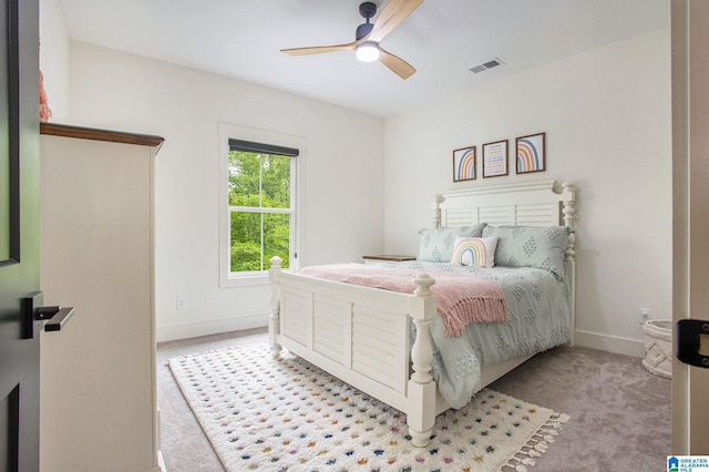 bedroom featuring baseboards, visible vents, ceiling fan, and light colored carpet