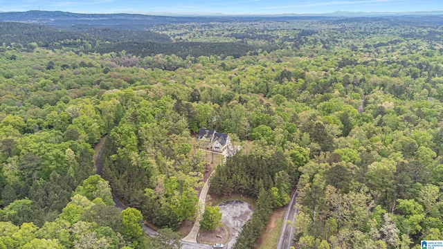 birds eye view of property featuring a view of trees