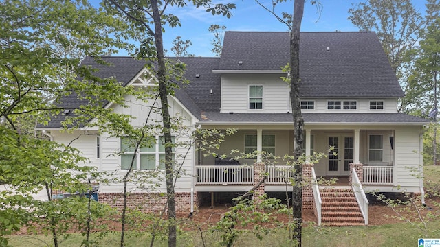 view of front of property with stairs, a porch, and roof with shingles