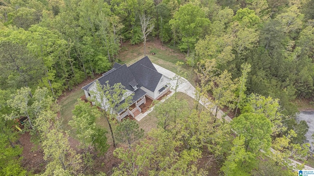 drone / aerial view with a wooded view