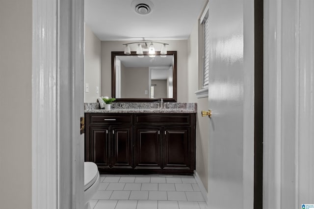 bathroom with vanity, tile patterned flooring, and toilet