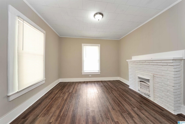 unfurnished living room with ornamental molding, dark hardwood / wood-style floors, and a brick fireplace