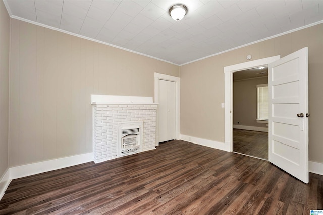 unfurnished living room featuring ornamental molding, dark wood-type flooring, and a fireplace