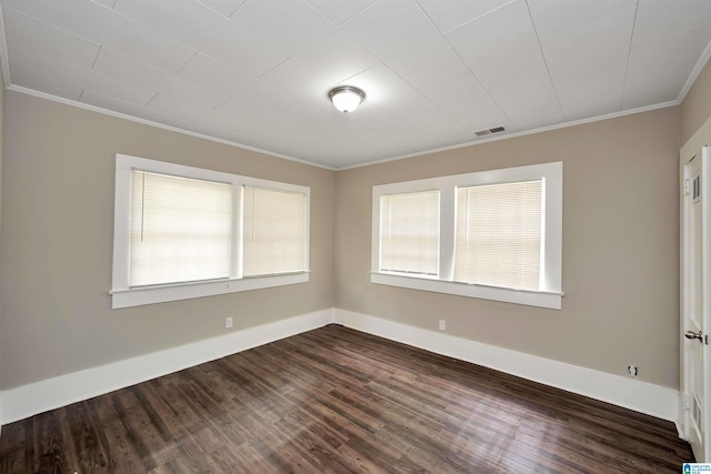 spare room featuring dark hardwood / wood-style flooring and ornamental molding