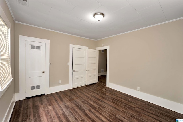 unfurnished bedroom featuring dark hardwood / wood-style flooring and ornamental molding