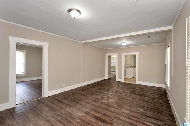 unfurnished room with dark wood-type flooring and crown molding