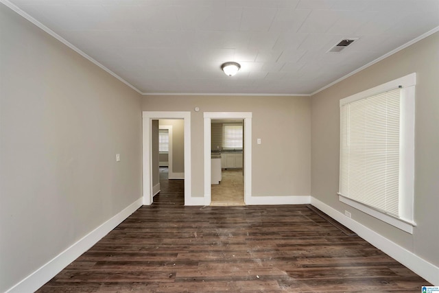 unfurnished room featuring dark wood-type flooring and crown molding