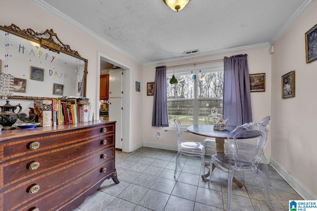 dining room with baseboards, ornamental molding, and a textured ceiling