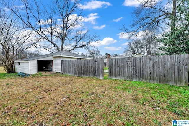 view of yard featuring an outbuilding, fence, and an outdoor structure