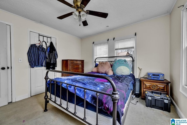 bedroom featuring a textured ceiling, ceiling fan, baseboards, and light colored carpet