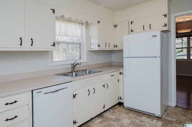 kitchen featuring white appliances, stone finish floor, light countertops, white cabinetry, and a sink