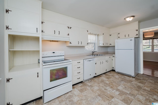 kitchen featuring light countertops, white cabinetry, a sink, white appliances, and under cabinet range hood