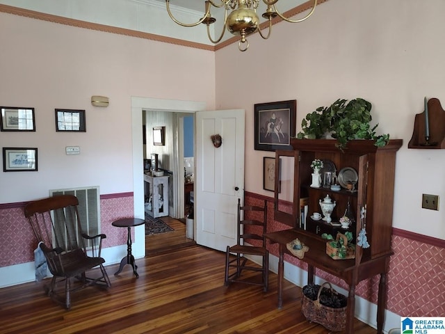 sitting room with visible vents, dark wood finished floors, baseboards, and an inviting chandelier