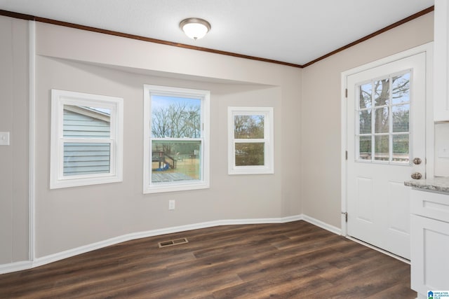 entrance foyer with dark wood-type flooring and crown molding