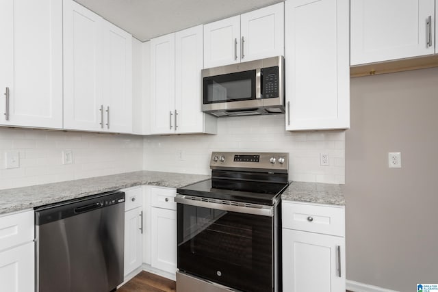 kitchen with stainless steel appliances and white cabinets