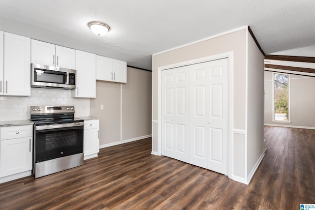 kitchen with tasteful backsplash, stainless steel appliances, light stone countertops, white cabinetry, and dark hardwood / wood-style floors