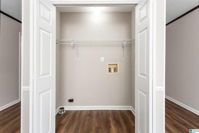 laundry room with a textured ceiling, washer hookup, wood walls, and dark hardwood / wood-style flooring