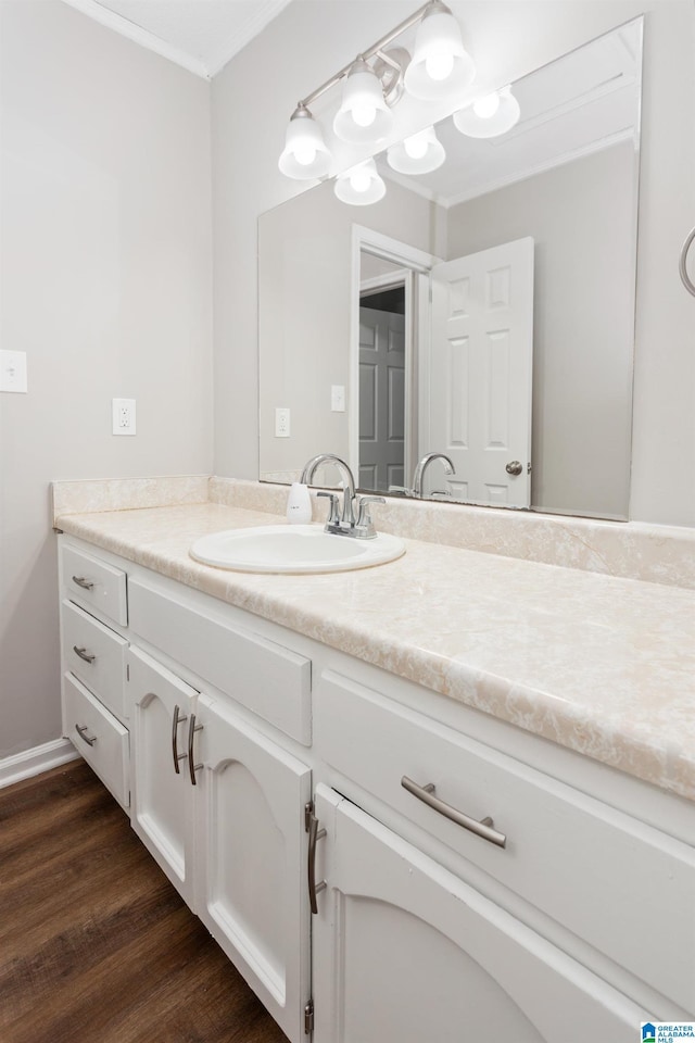 bathroom featuring vanity, crown molding, and hardwood / wood-style floors