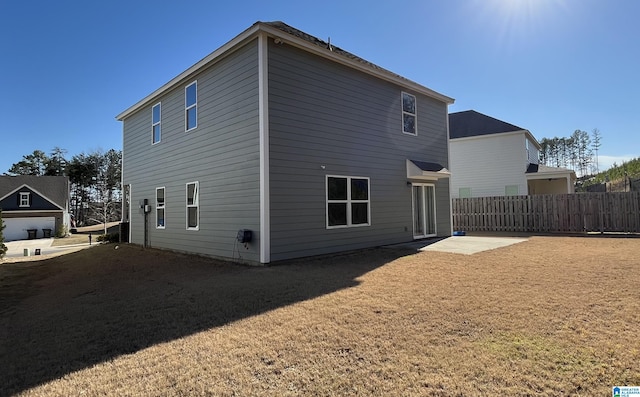 rear view of property with a patio area, fence, and a yard