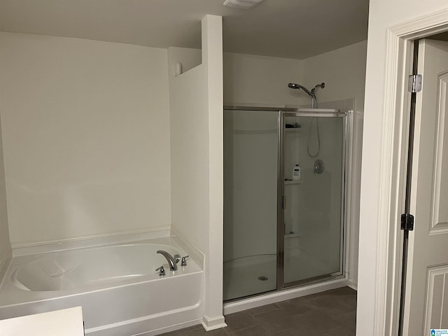 bathroom with a stall shower, tile patterned floors, and a bath