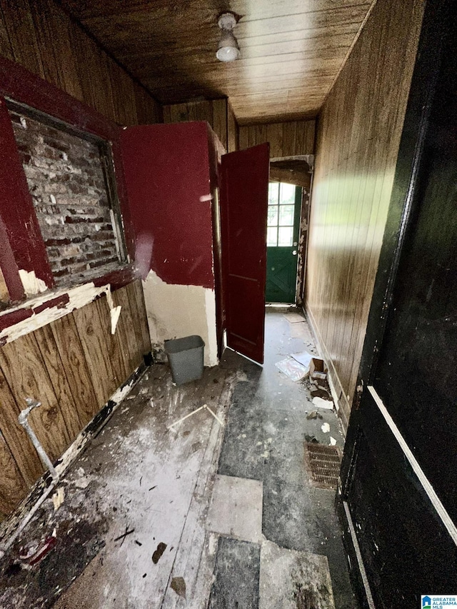 interior space featuring wooden walls and wood ceiling